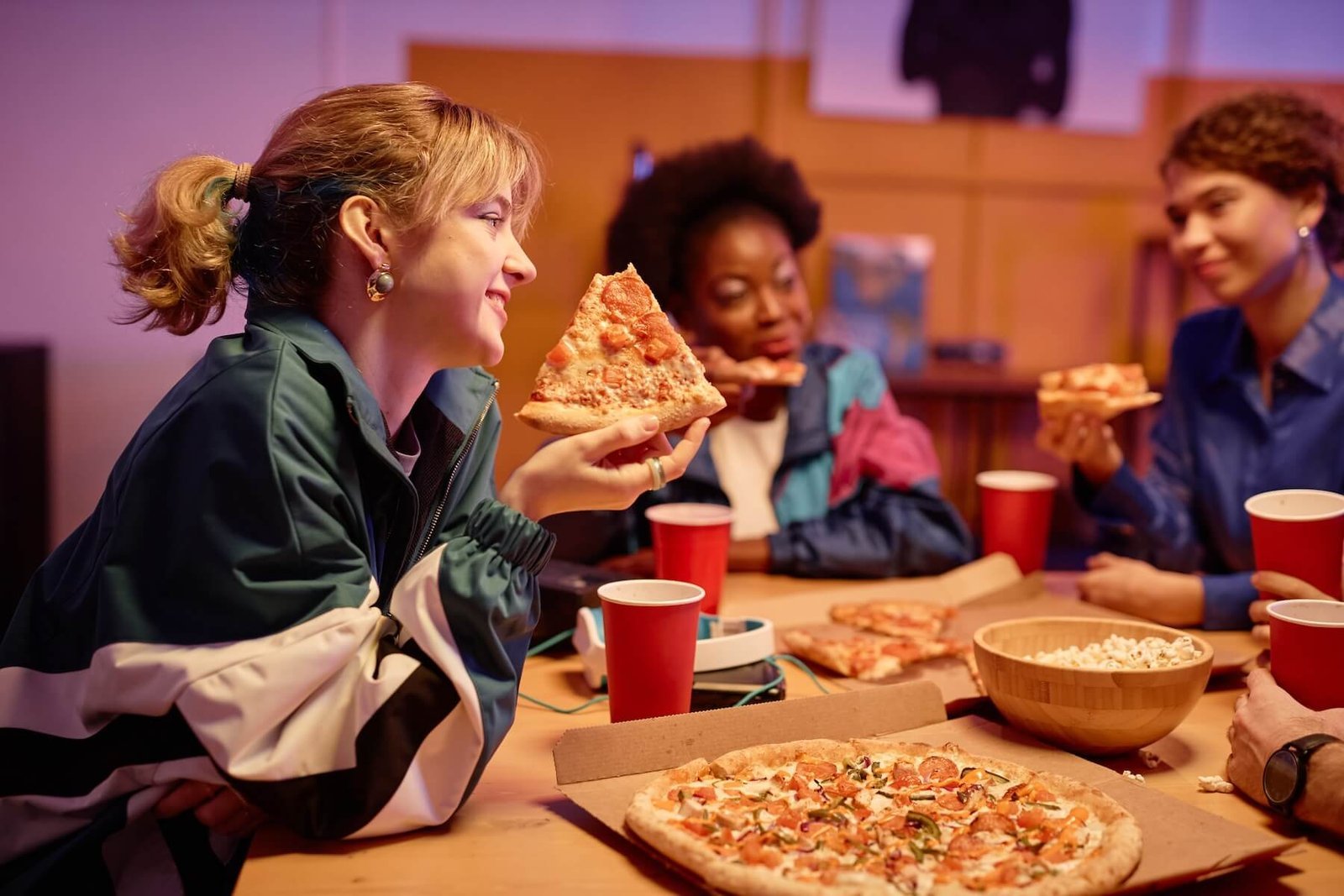 Friends sharing pizza at a table