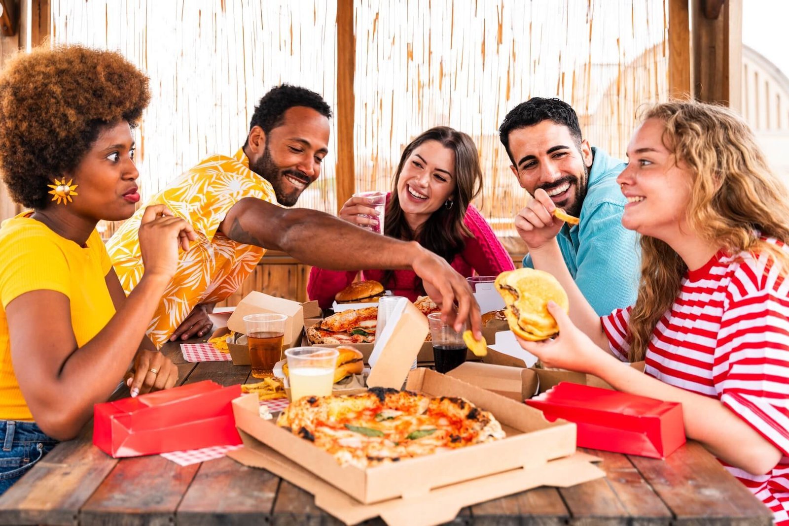 Guest holding a pizza slice